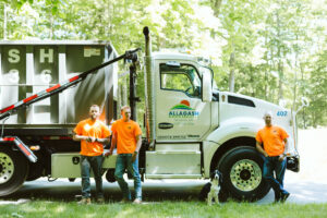 Dan, Alec, & Andrew Emerson of Allagash Waste Services standing near roll off truck